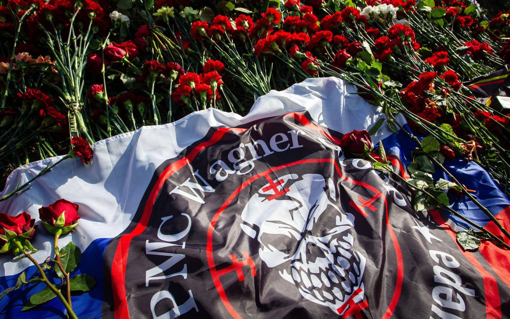 Flowers laid in memory of Yevgeny Prigozhin at a spontaneous memorial near the PMC Wagner headquarters in St. Petersburg.