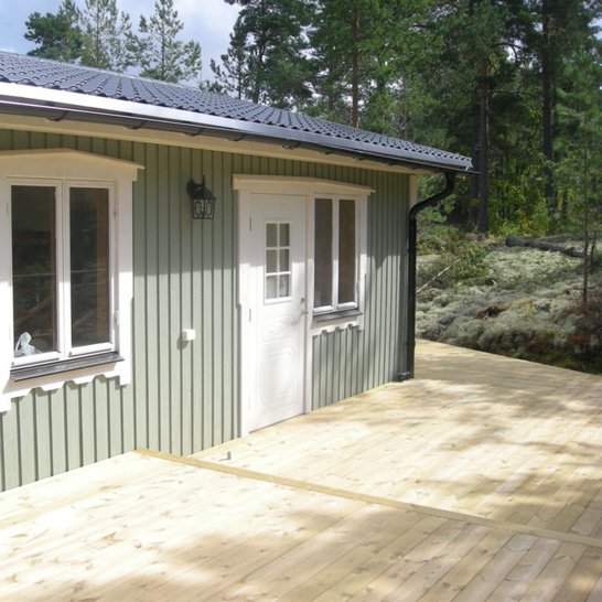 Simple green shed with accented windows