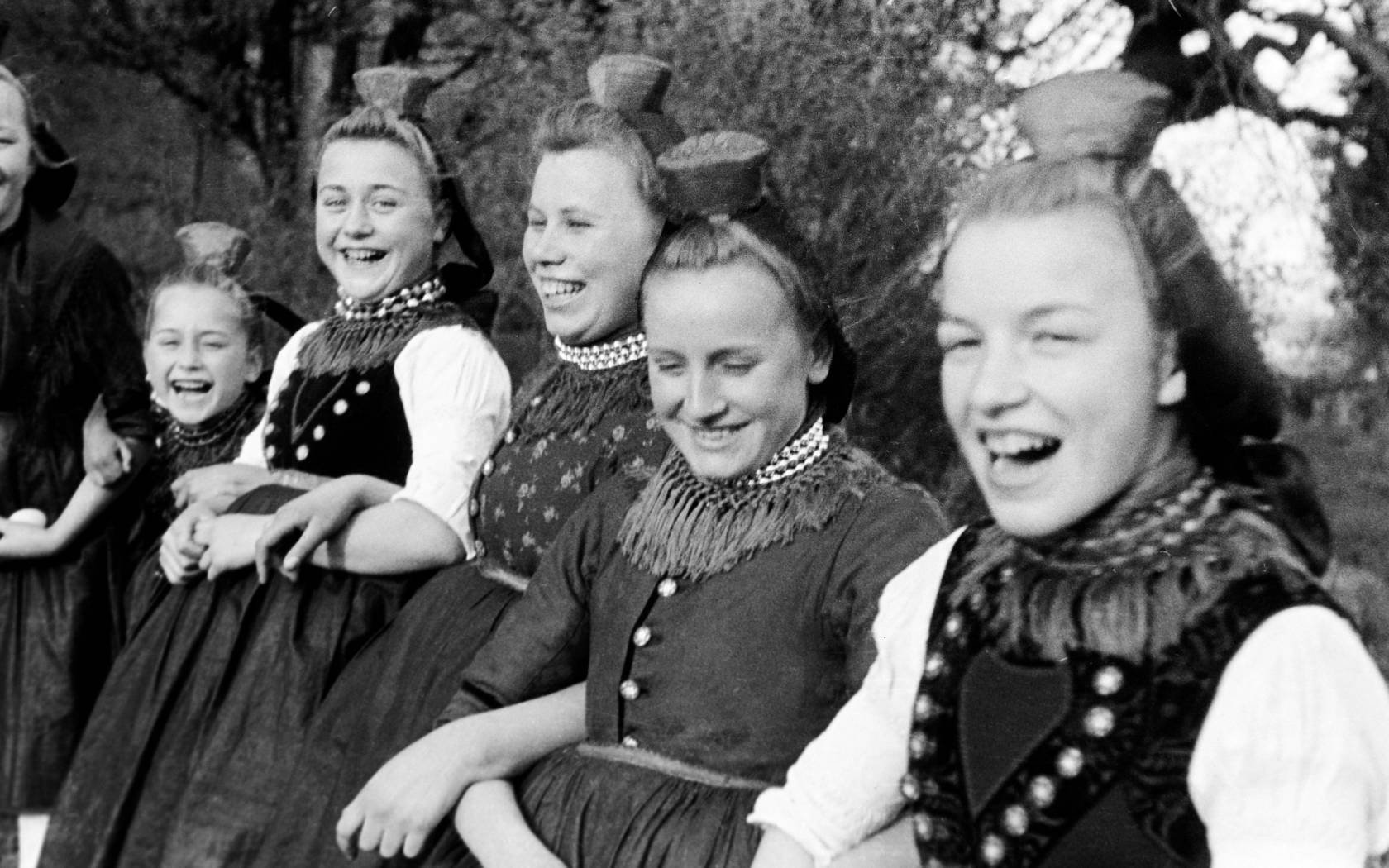 Amused young women in traditional costume on Easter Sunday.