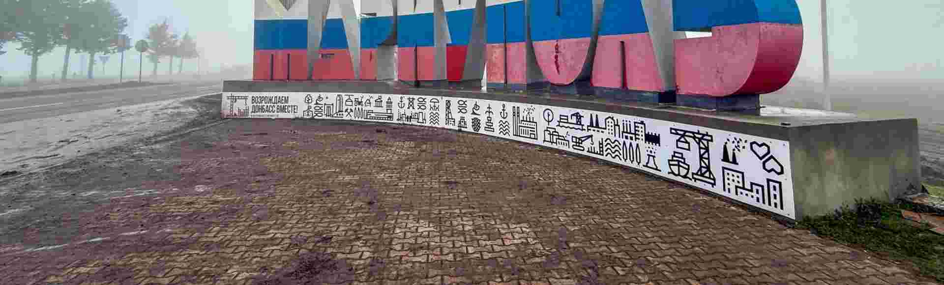 Mariupol's city sign painted in the colours of the Russian flag.