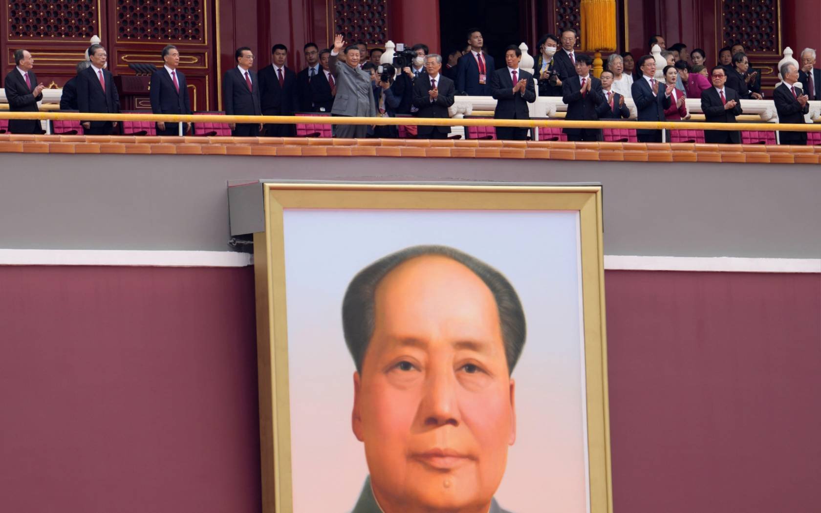Xi Jinping waves above a large portrait of the late leader Mao Zedong during a ceremony to mark the 100th anniversary of the founding of the ruling Chinese Communist Party.