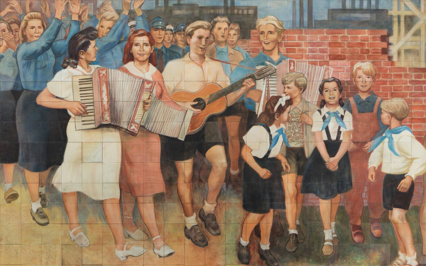 East German pioneers and musicians depicted in the porcelain frieze 'Building of the Republic' designed by German artist Max Lingner (1952–1953) on the building of the Council of Ministers of East Germany (former Reichsluftfahrtministerium), now the Detlev-Rohwedder-Haus in Berlin, Germany. Credit: Azoor Photo / Alamy Stock Photo.