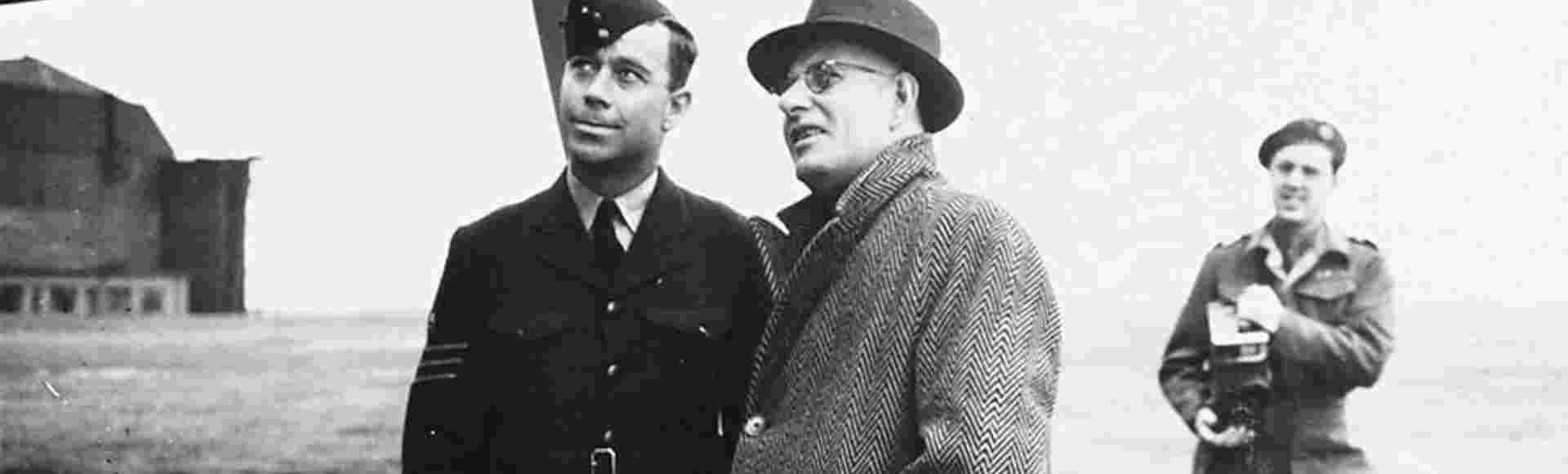 Australian Premier John Curtin talks with Flight Sergeant Harry Tickle, responsible for maintaining Lancaster bomber G for George, 1944, RAF. Credit: piemags/ww2archive