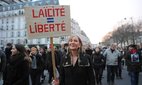 More than 1.5 million people take part in a march to support freedom of expression.