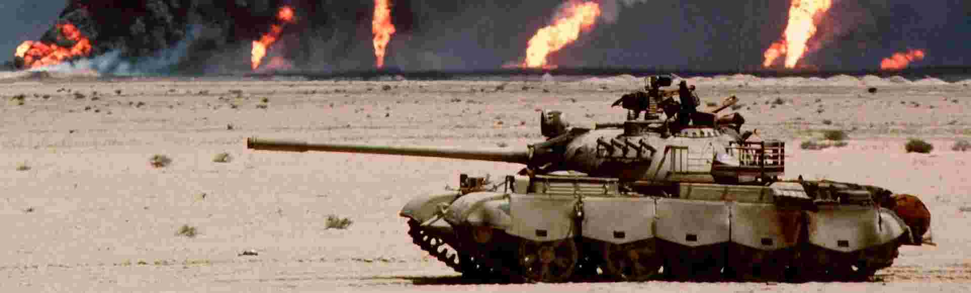 An abandoned Russian-made T-62 tank in the desert in front of burning oil wells in Kuwait, in February-March 1991.