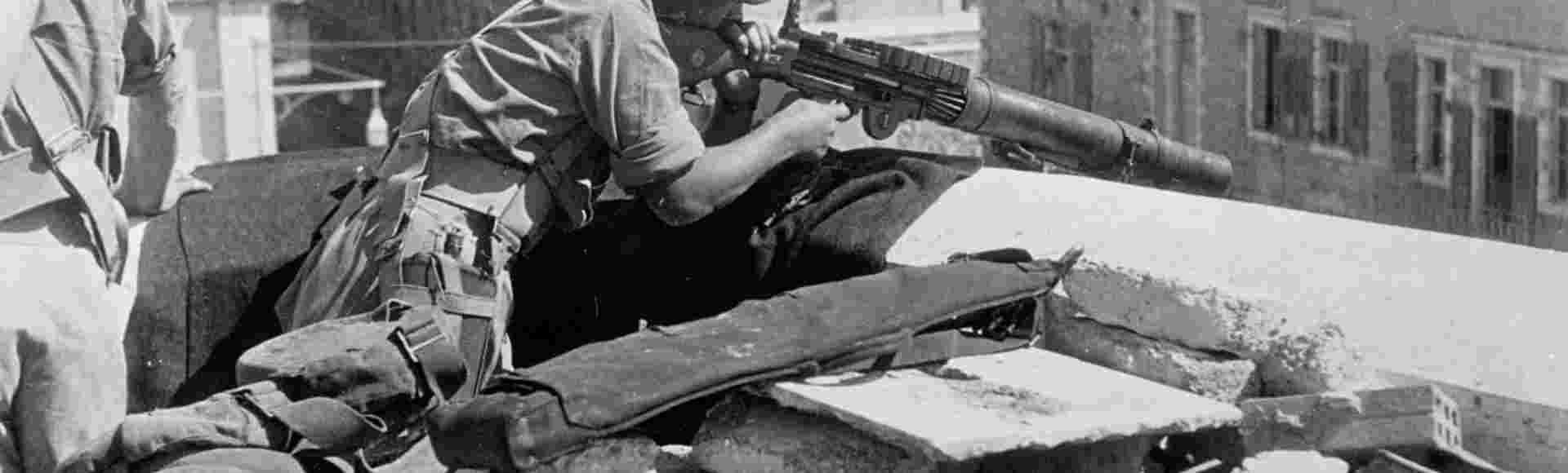 A British soldier manning a Lewis gun on a rooftop in the Old City of Jerusalem, in October 1938.