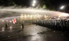 Riot police use a water cannon during an opposition protest against 'the Russian law' near the Parliament building in Tbilisi, Georgia, on May 1, 2024.