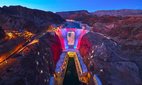 The Hoover Dam in Nevada lit up with the United States flag.