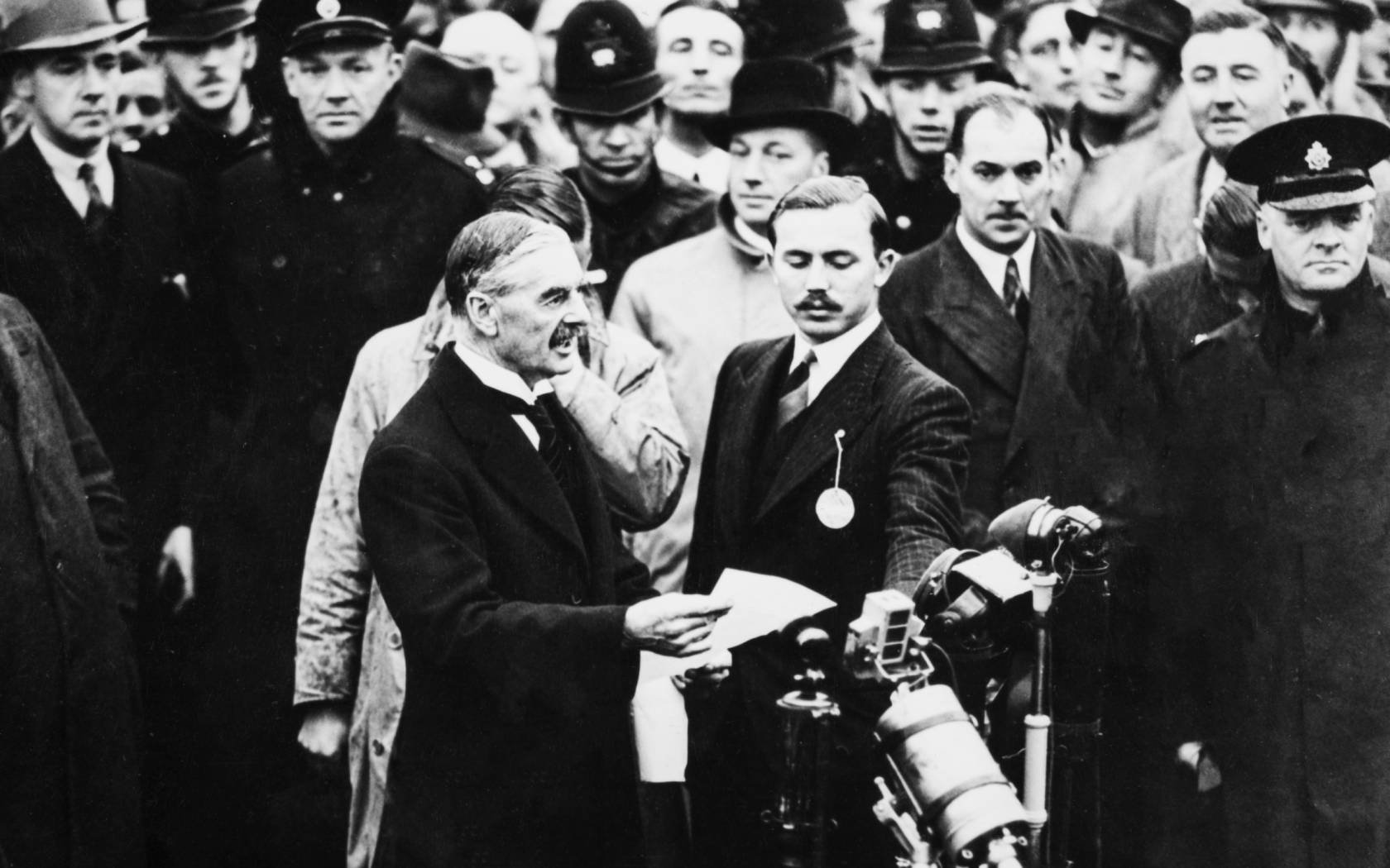 Neville Chamberlain arrives at Heston Aerodrome, London after meeting Adolf Hitler.