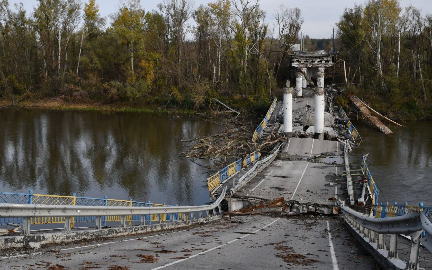 A destroyed bridge crossing the Siverskyi Donets river.