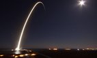 The SpaceX Falcon 9 rocket streaks across the night sky.