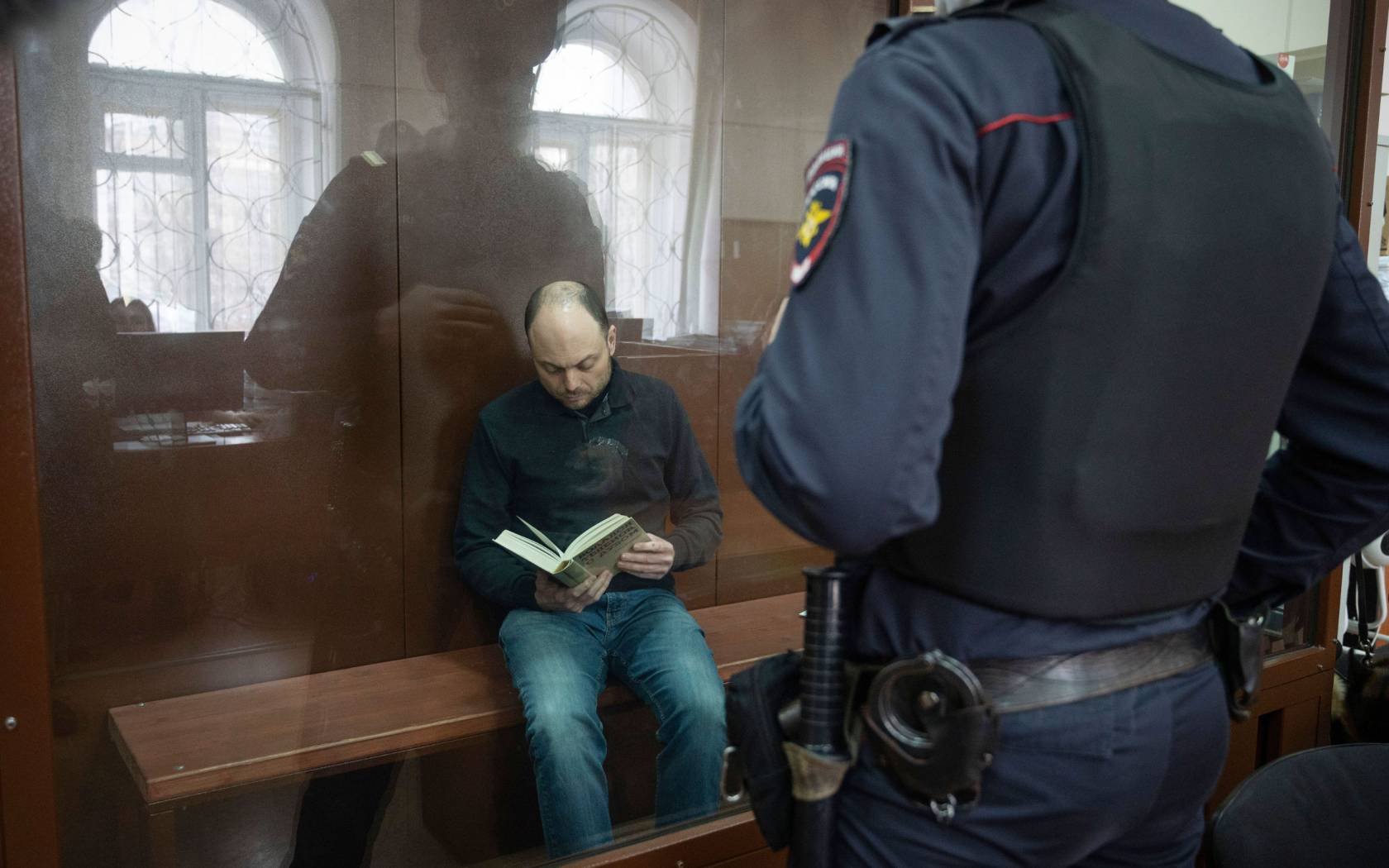 Russian opposition activist Vladimir Kara-Murza sits in a cage in a courtroom prior to a court session in Moscow, Russia, 2023.