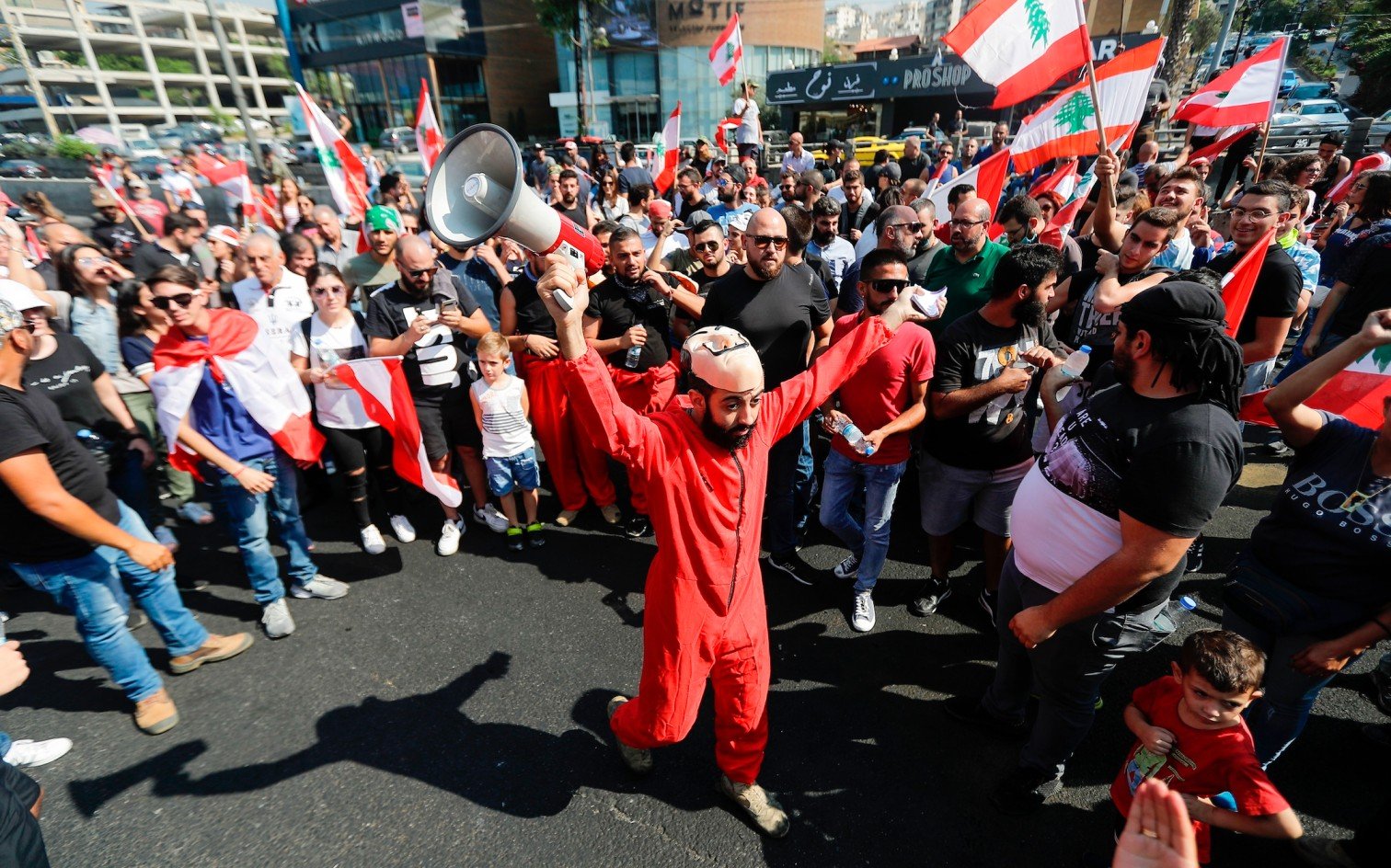 A Lebanese protester chants wearing a mask from Spanish crime show 'The Heist'.