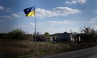 A Ukrainian flag seen fluttering near Yampil, a settlement and railroad station in Lyman, Donetsk region. The liberation of Lyman was seen as a symbolic victory in the east. Credit: Sipa US / Alamy Stock Photo.
