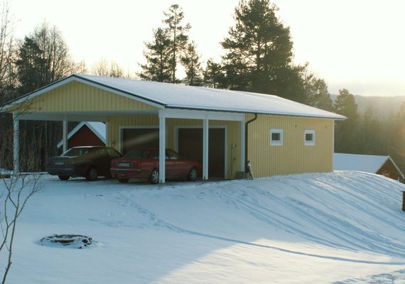 Yellow garage with double carport in front