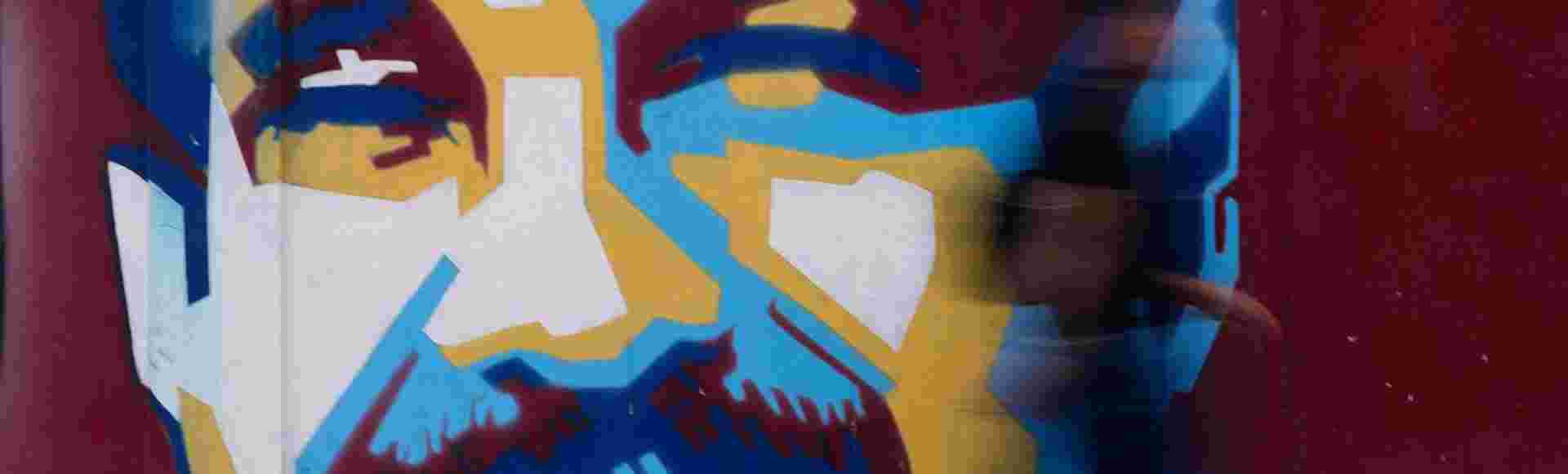 A pedestrian walks past a mural of Venezuelan President Nicolas Maduro Sunday, 4 January, 2026.