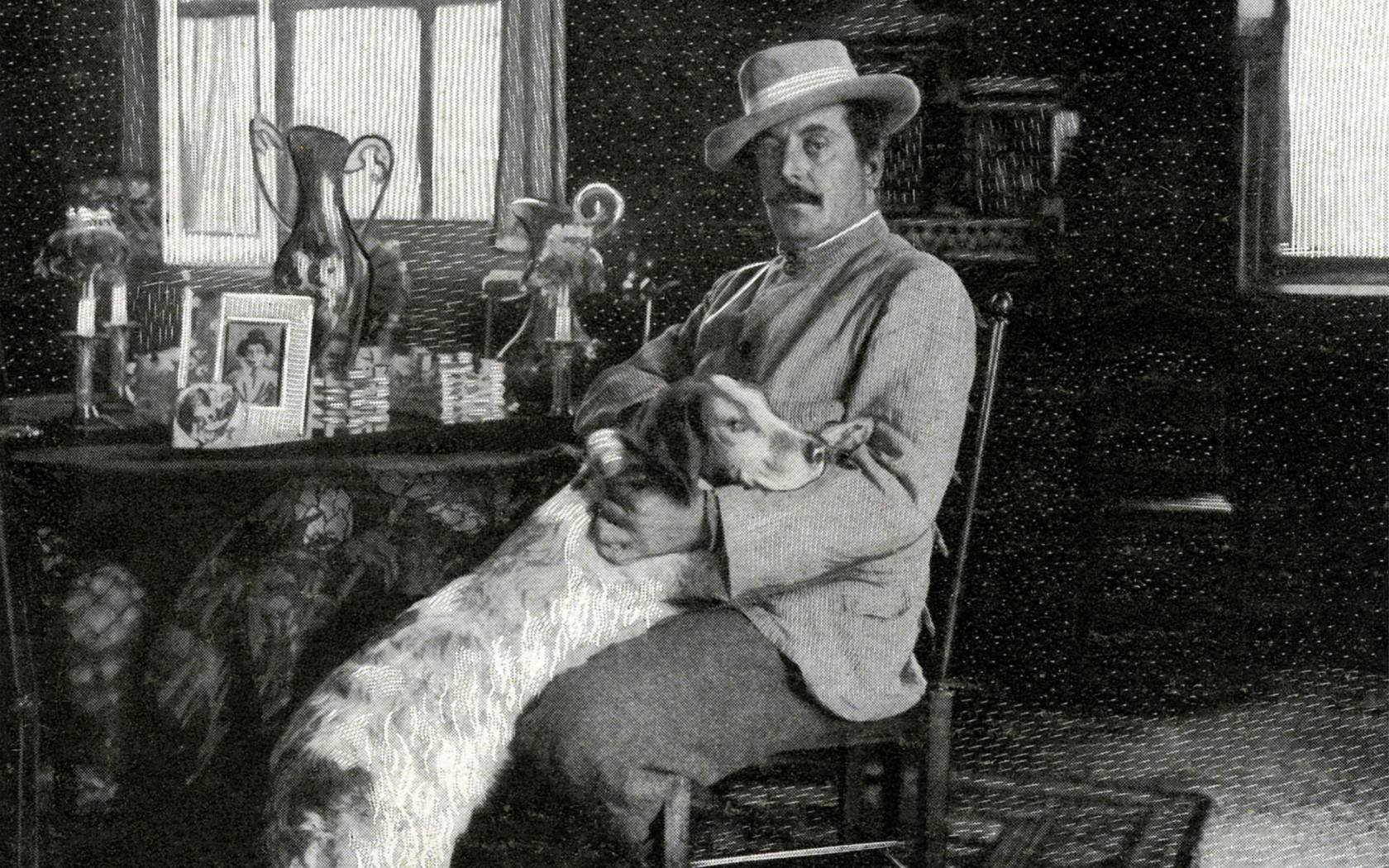 Giacomo Puccini at home with his dog.