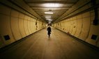 A visitor walks in a formely secret air raid tunnel called Third Avenue in London. The once secret tunnels were built 100 feet under central London in 1940 as fully equipped air raid shelters and could accommodate 8000 people. They have since been used by MI6 and the Public Records Office to hold 400 tonnes of secret documents. Credit: Peter Macdiarmid