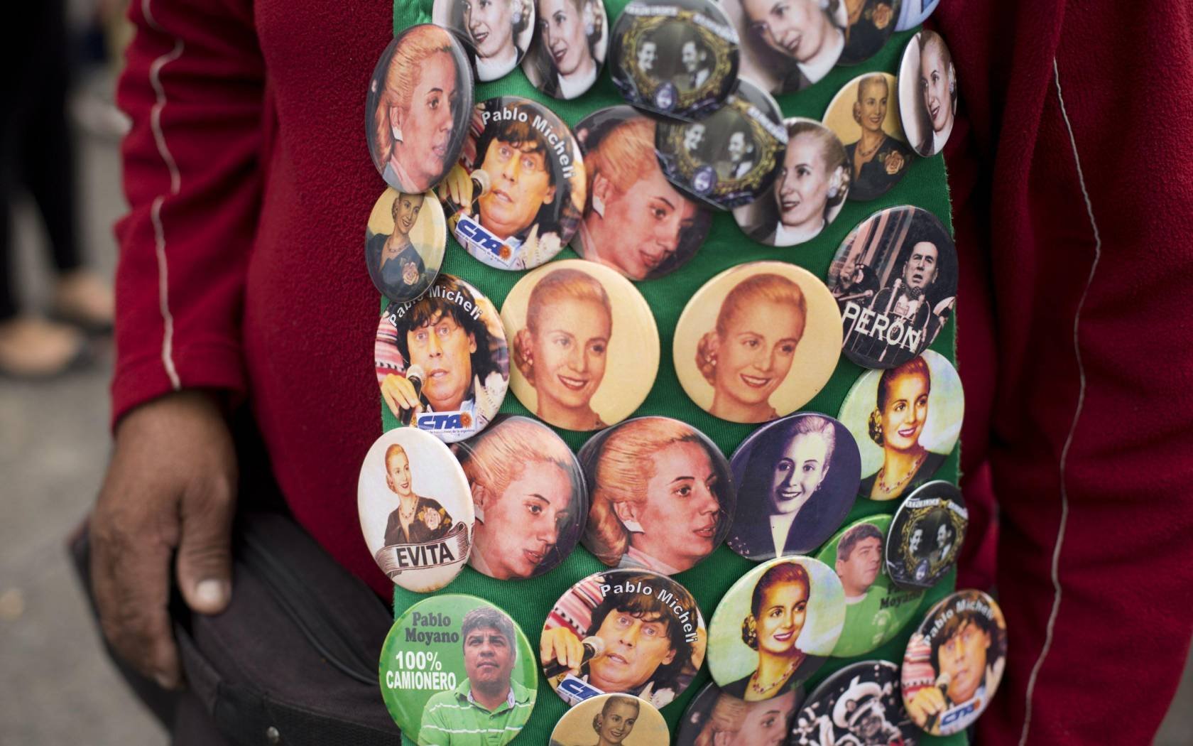 A man sells pins of Argentine leaders such as former President Juan Domingo Peron and his wife Eva during a May Day march in Buenos Aires, Argentina.