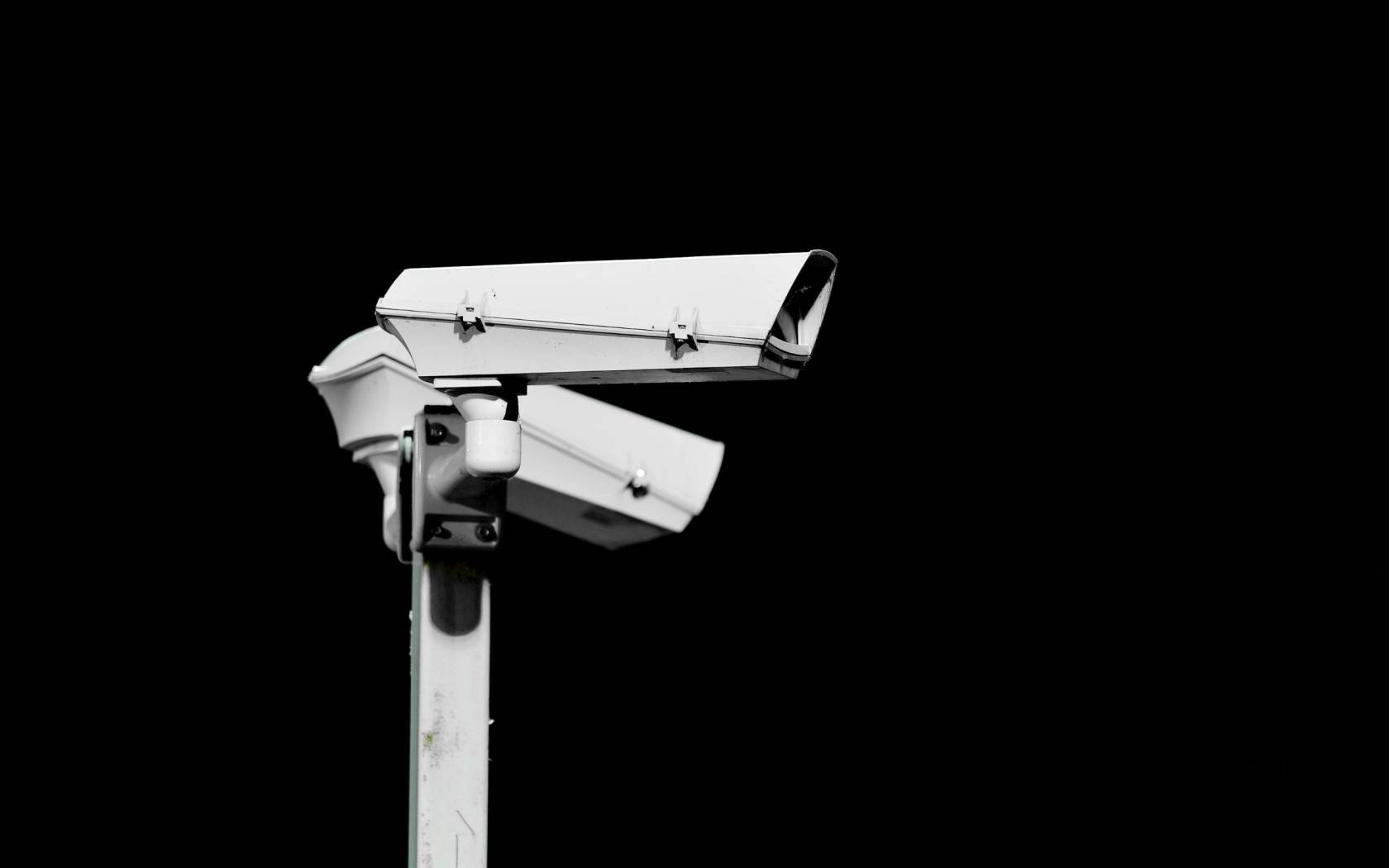 Two surveillance cameras isolated on black background.