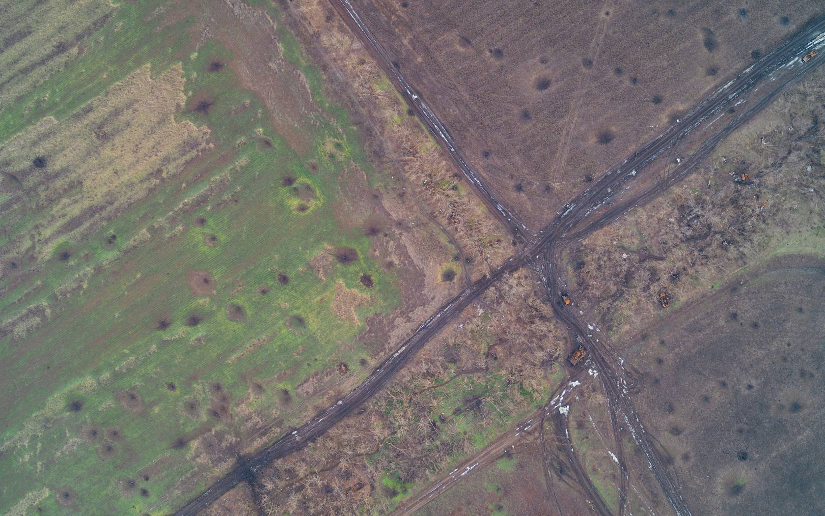 An artillery-cratered crossroads in Donbas.