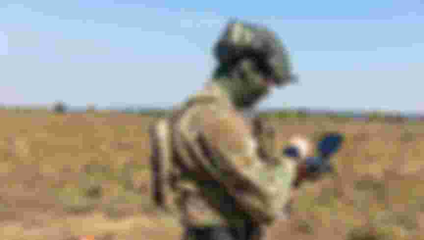 Soldier flying a drone