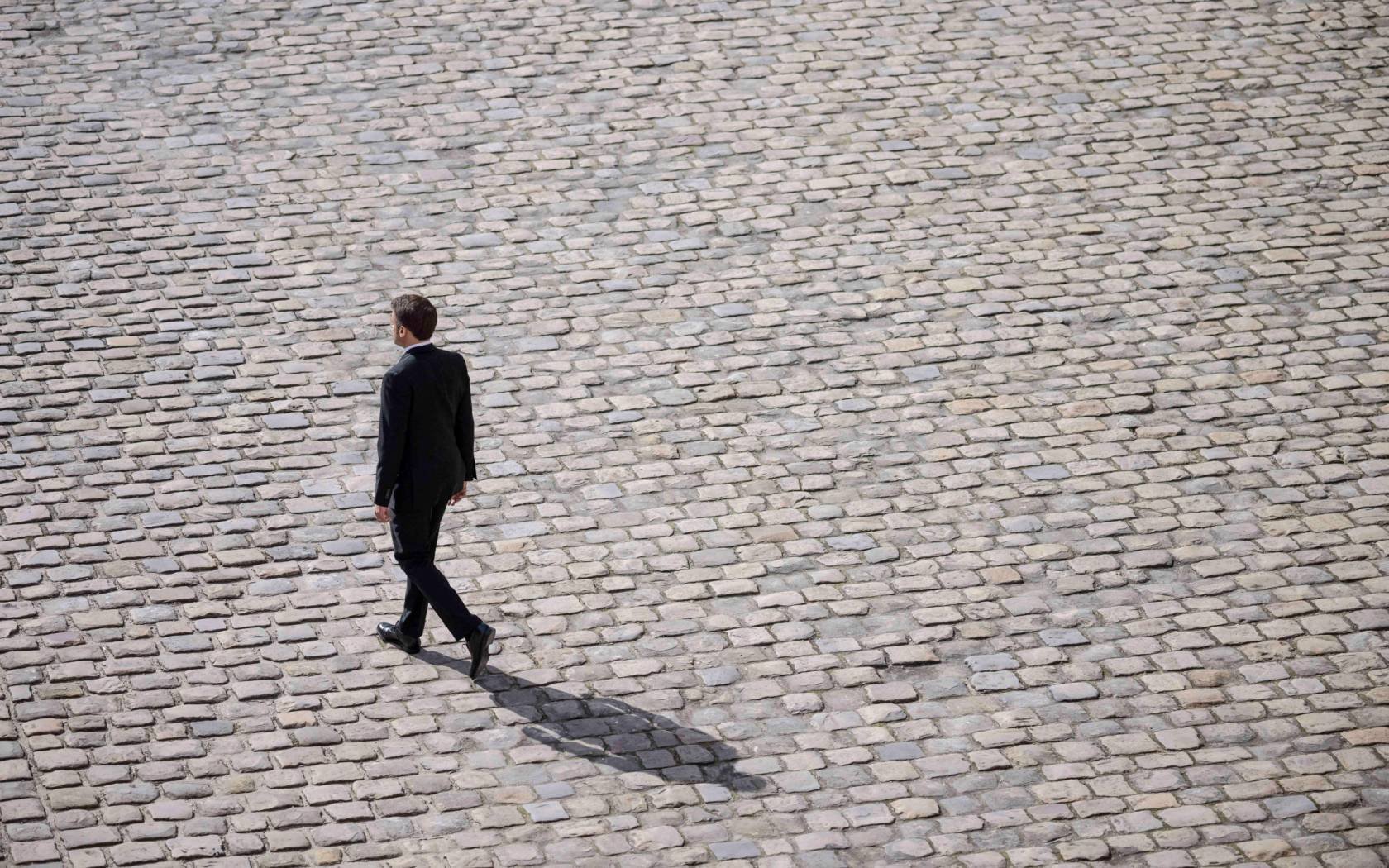 Emmanuel Macron walks alone during a ceremony for late French politician and admiral, Philippe de Gaulle, the son of Charles de Gaulle