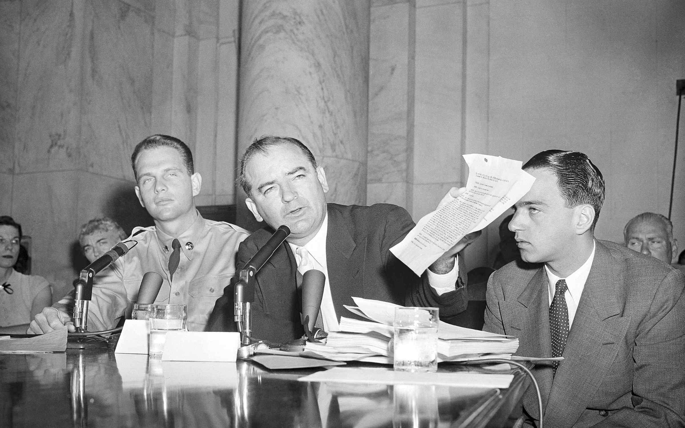 Senator Joseph McCarthy with G. David Schine (left) and Roy Cohn (right) at a session of the McCarthy-Army dispute hearing on June, 7, 1954.