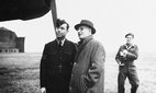 Australian Premier John Curtin talks with Flight Sergeant Harry Tickle, responsible for maintaining Lancaster bomber G for George, 1944, RAF. Credit: piemags/ww2archive