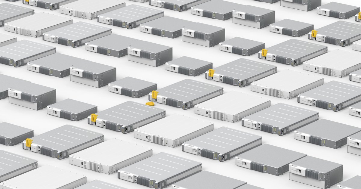A close-up of several Polarium lithium-ion battery modules lying on a flat, white surface.