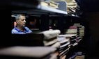 An archivist checks books and documents at the Iraq National Library and Archives in Baghdad.