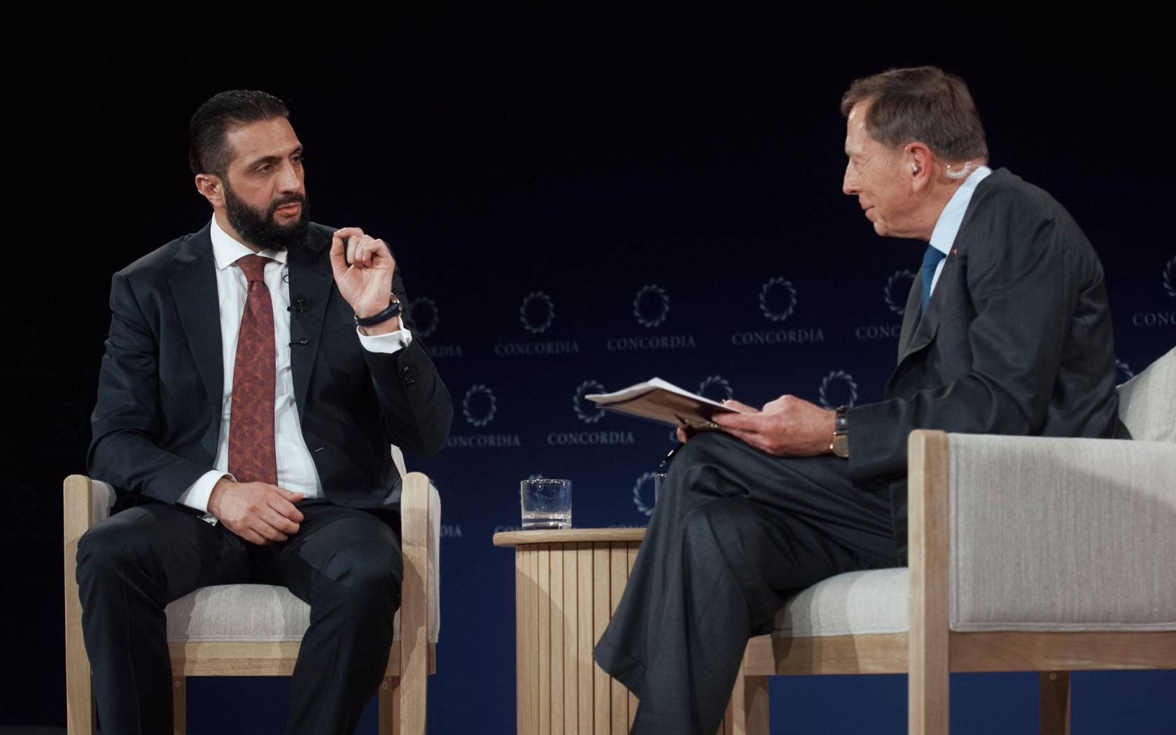 Syrian President Ahmed al-Sharaa speaks with former United States Army General David Howell Petraeus during the Concordia Annual Summit, in New York, Monday, Sept. 22, 2025.
