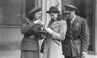 Mrs Odette Sansom showing her George Cross medal to her daughter François after the investiture ceremony at Buckingham Palace, on 19 November 1946.