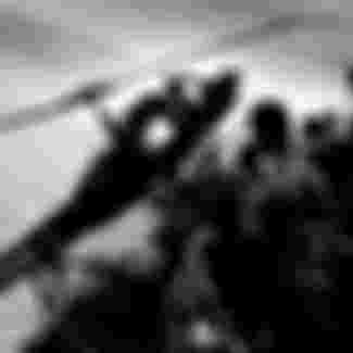 A helicopter is pushed off the overcrowded deck of the aircarft carrier USS Hancock (CV-19) off the coast of South Vietnam during the fall of Saigon.