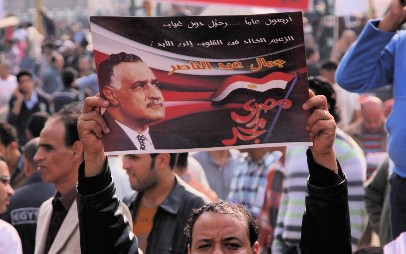 A protestor holds up an image of Nasser during the Arab Spring in Egypt.