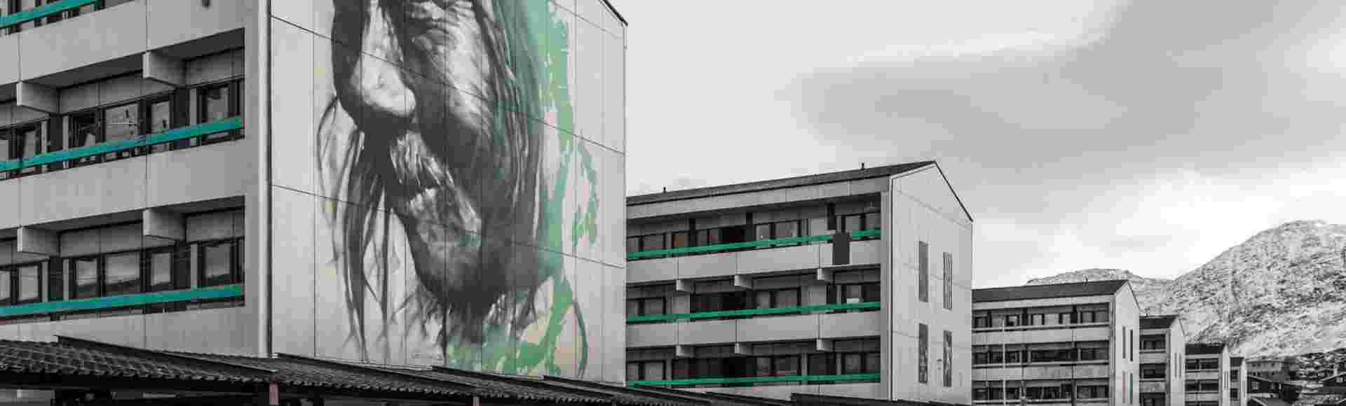 A mural of an old shaman on council housing in Nuuk, Greenland.