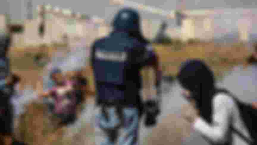 A photojournalist watches as Palestinians protest in the West Bank. Credit: Nidal Alwaheidi/SOPA Images/LightRocket via Getty Images.