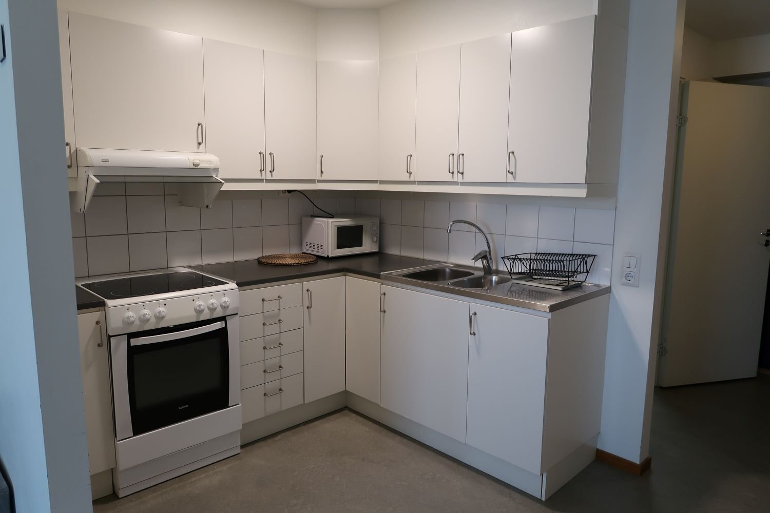 Kitchen with stove, oven, sink, microwave, and cupboards.