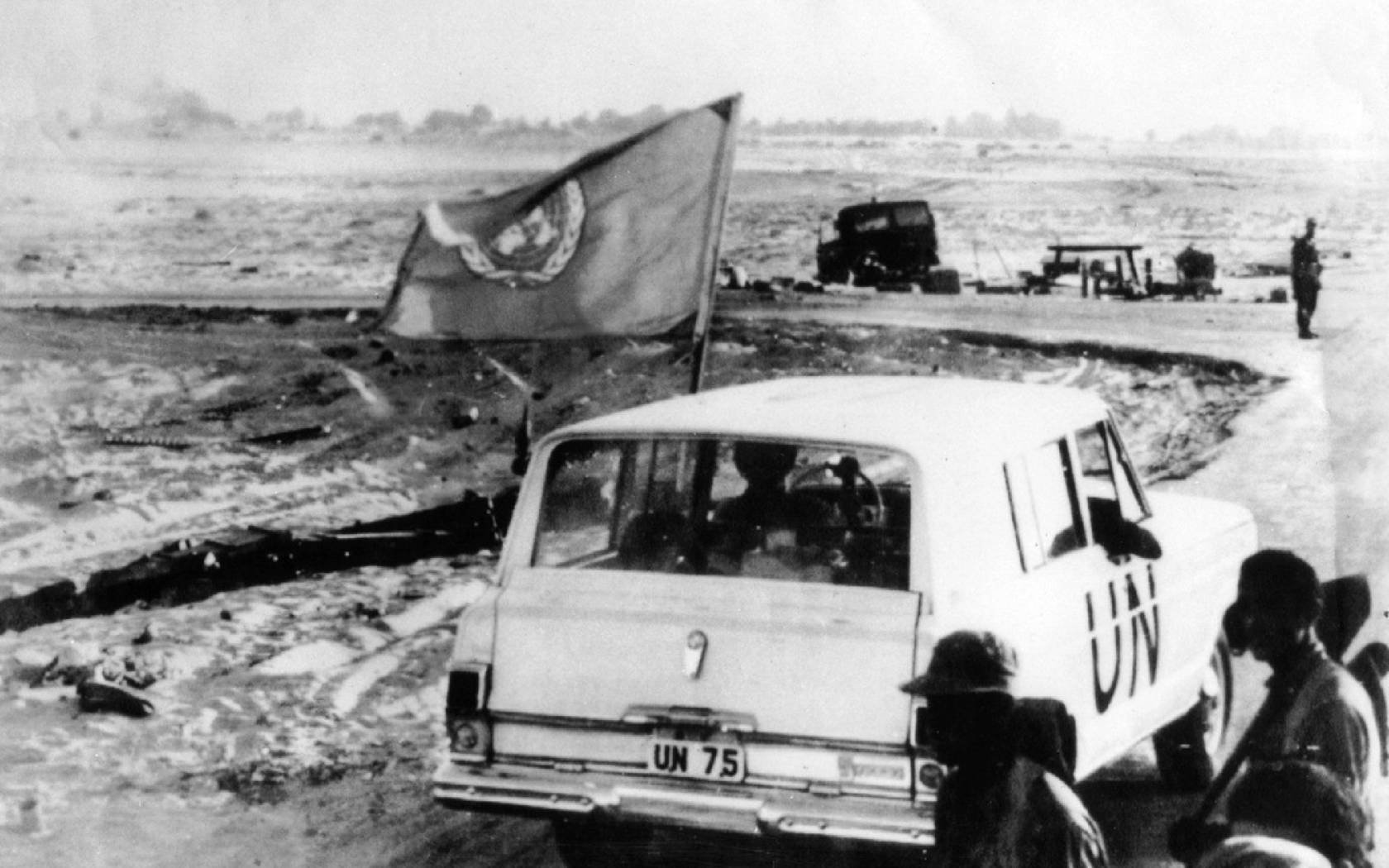 A United Nations vehicle passing Israeli troops near Quantara on the east bank of the Suez Canal. A U.N. observer was posted on either side of the canal to supervise the cease-fire between Israel and Egypt.
