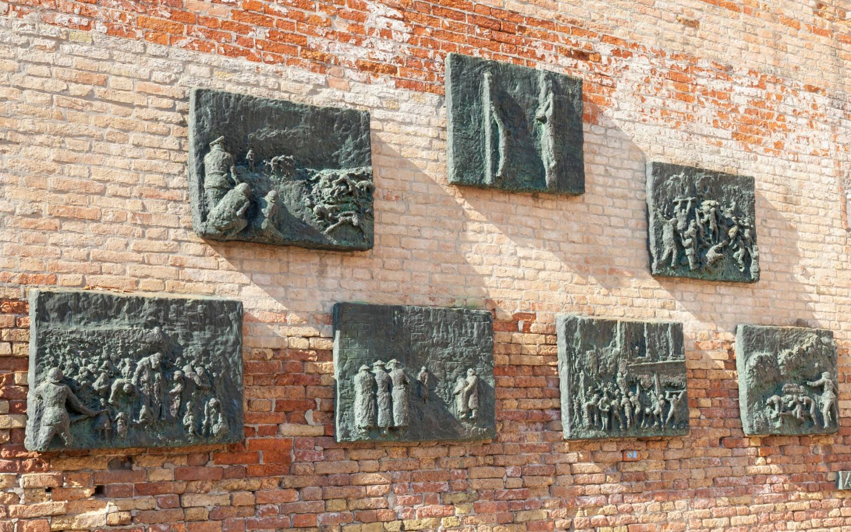 The seven plaques on the Holocaust Memorial wall at Campo de Gheto Novo in Venice.