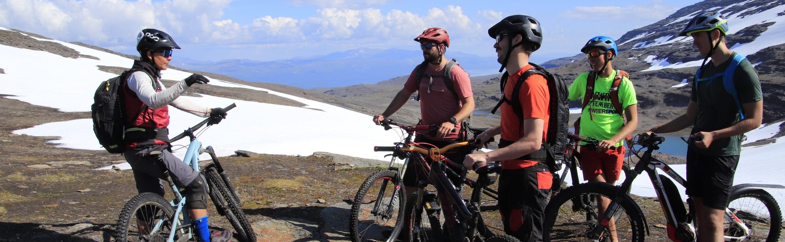 Mountain biker with daypack and waterproof gear on Abisko singletrack