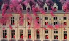 Smoke billows near windows as performers participate in the opening ceremony of the 2024 Paris Olympics.