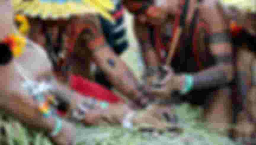 Brazilian Kayapo and Xerente indians prepare to set fire on the Holy Pyre using a traditional method during the Kari-Oca opening ceremony in the sidelines of the Rio+20 environmental summit on June 13, 2012 in Jacarepagua, Rio de Janeiro, Brazil. The UN Conference on Sustainable Development opened Wednesday, launching a new round of debate on the future of the planet, its resources and people, 20 years after the first Earth Summit. AFP PHOTO/ANTONIO SCORZA (Photo credit should read ANTONIO SCORZA/AFP/GettyImages)