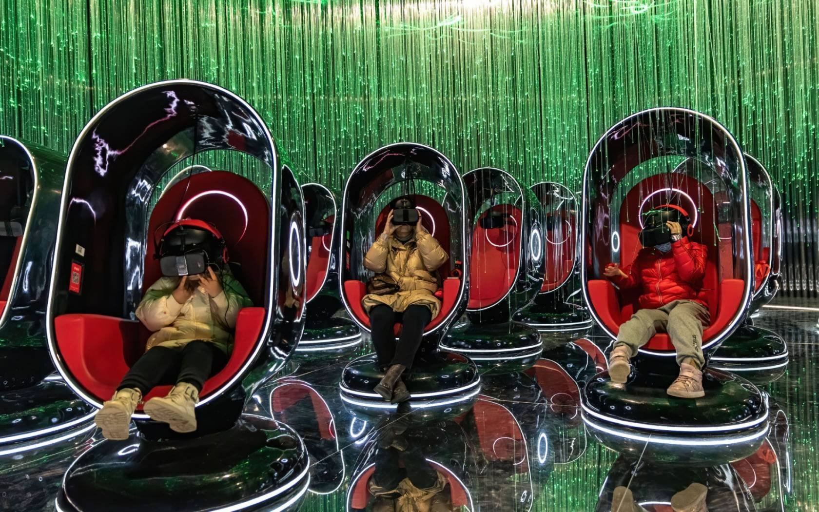 People wearing VR headsets watch films during an exhibition at 'AHSPACE' immersive live broadcast base in Hefei, Anhui Province of China.