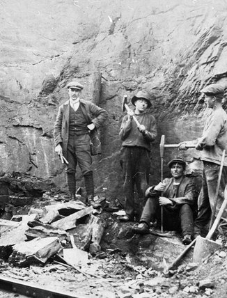 Four railroad workers are building foundations for overhead wire poles on the railroad in 1913 in Björkliden