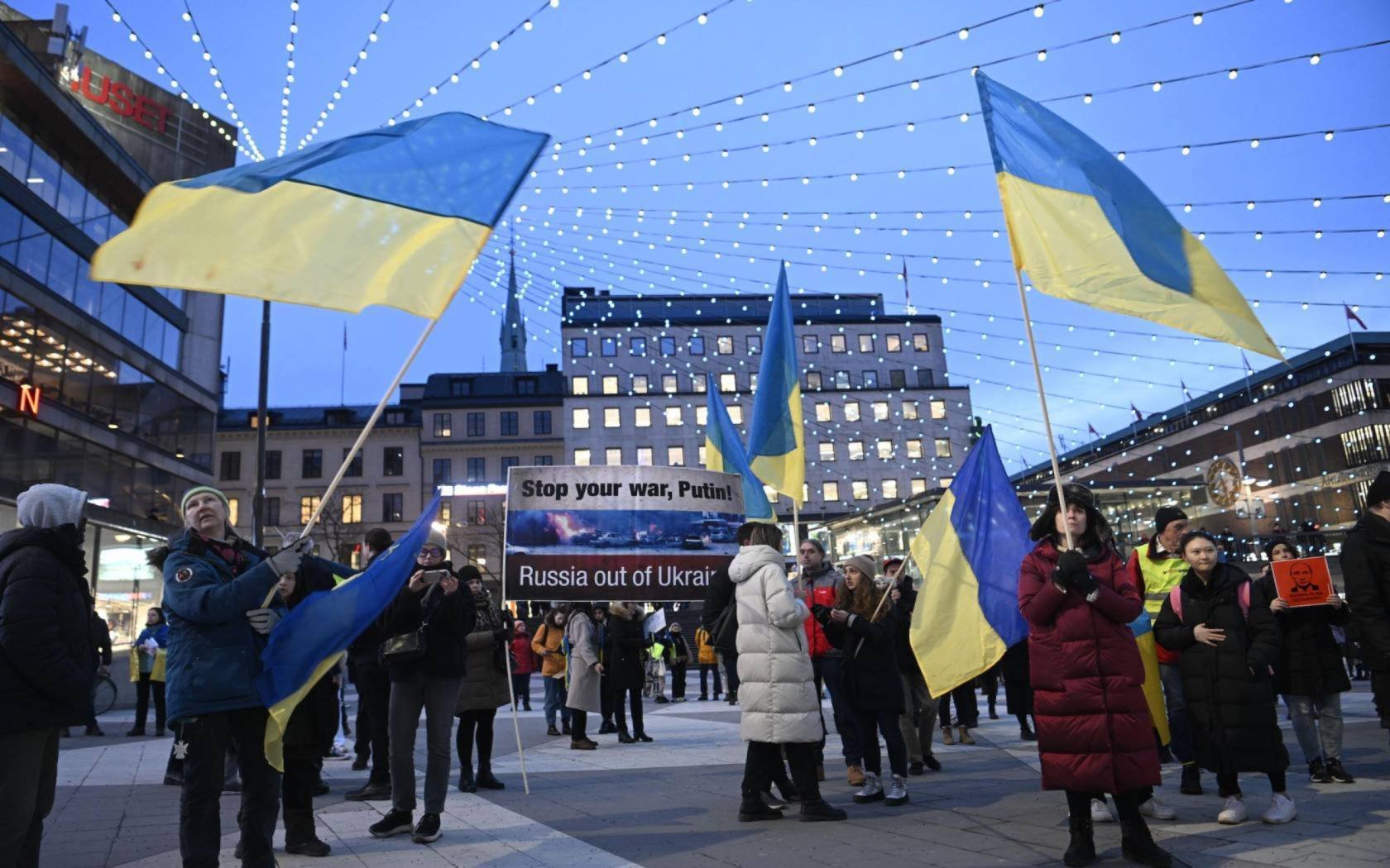 Swedish protesters hold Ukrainian flags and anti-war banners during a demonstration to protest the Russian invasion in Ukraine