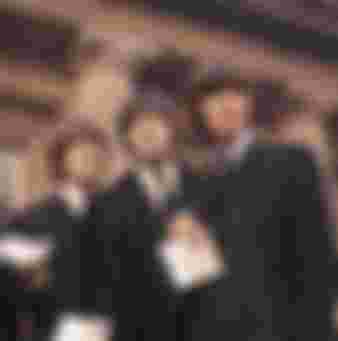 The Beatles showing their MBE Insignias after receiving them from the Queen.