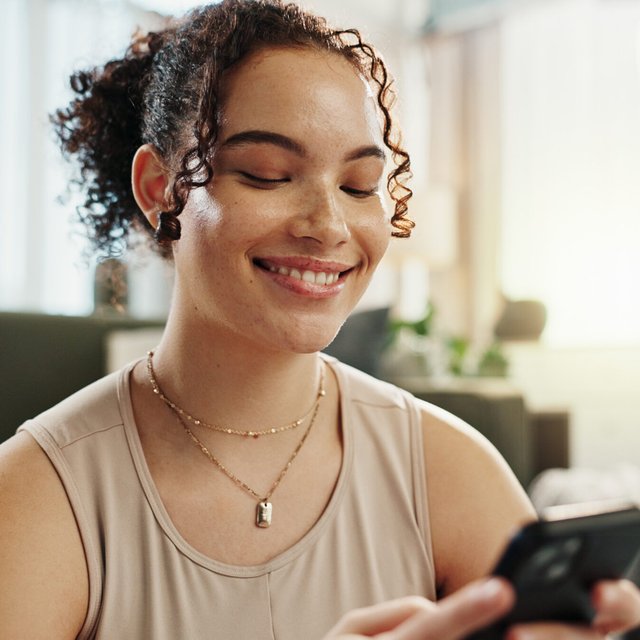 Break, smile and woman with smartphone, yoga and search on social media, online and relax in home. Fitness, digital and routine for wellness, app and mobile for tips, pilates and healthy in house.