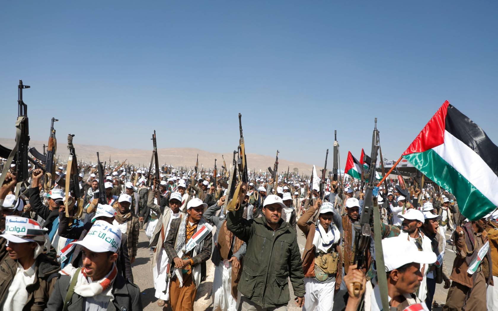 Newly-recruited Houthi militiamen march in a during a parade in Amran province, 20 December 2023.