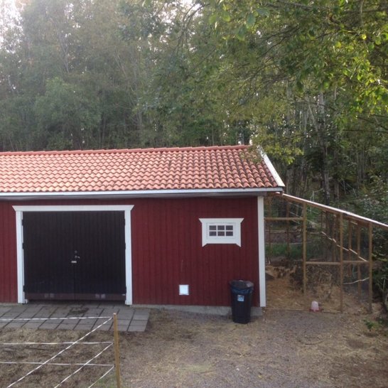 Small simple red barn with black door